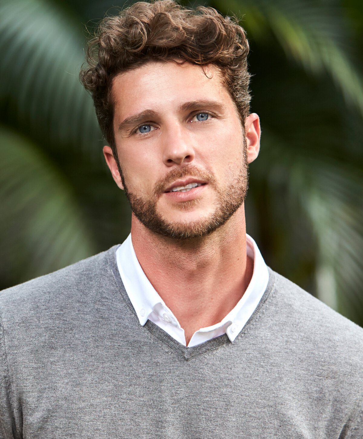 male manchester otoplasty patient model smiling in a gray sweater
